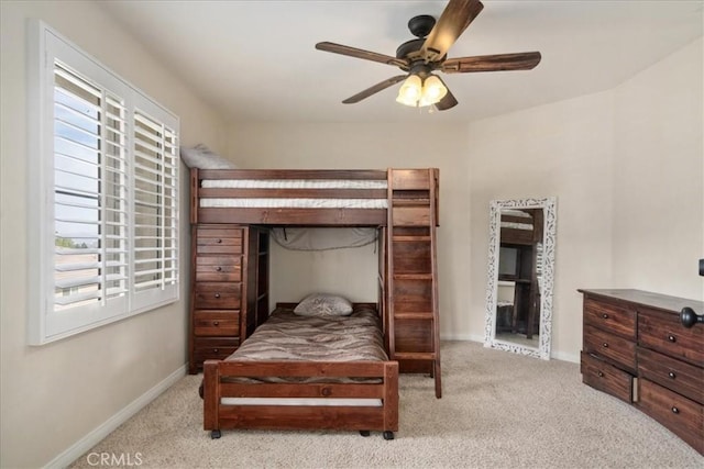 carpeted bedroom with baseboards and ceiling fan