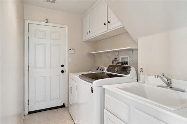 laundry room featuring washer and dryer, visible vents, a sink, and cabinet space