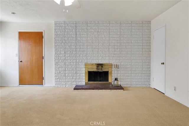living room with a ceiling fan, baseboards, a fireplace, and carpet flooring