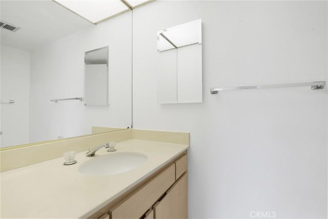 bathroom with visible vents and vanity