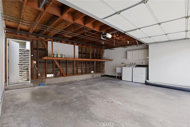 garage featuring washer and dryer and a garage door opener