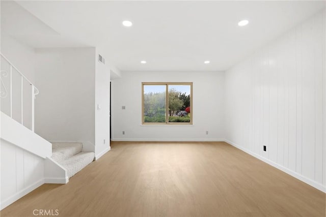 interior space with visible vents, light wood-style flooring, and stairway
