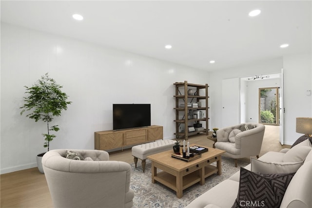living room with recessed lighting, light wood finished floors, and baseboards