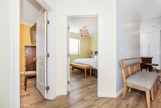 9336 Wayside Dr, Sunland, CA 91040 - corridor with crown molding, light wood finished floors, baseboards, and a chandelier