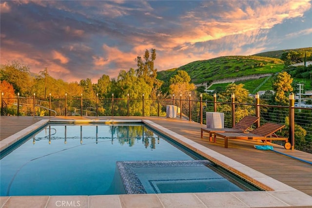 9336 Wayside Dr, Sunland, CA 91040 - pool at dusk with fence, a deck with mountain view, and a pool with connected hot tub