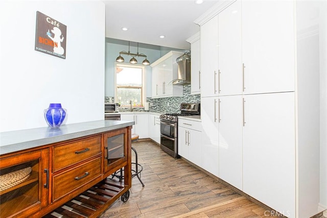 9336 Wayside Dr, Sunland, CA 91040 - kitchen featuring backsplash, range with two ovens, wood finished floors, a sink, and white cabinets