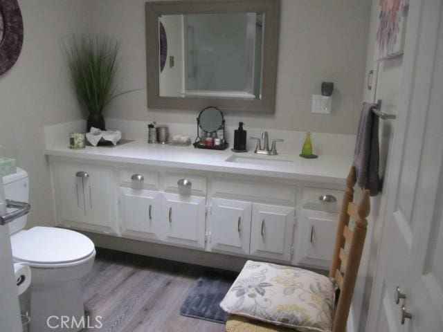 13730 Annandale Dr Unit M1-30G, Seal Beach, CA 90740 - bathroom with vanity, wood finished floors, and toilet