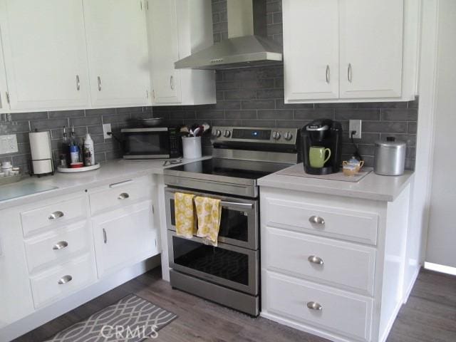 13730 Annandale Dr Unit M1-30G, Seal Beach, CA 90740 - kitchen featuring wall chimney range hood, white cabinets, appliances with stainless steel finishes, and dark wood-type flooring