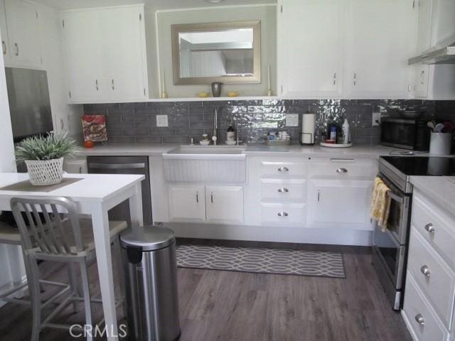 13730 Annandale Dr Unit M1-30G, Seal Beach, CA 90740 - kitchen with decorative backsplash, light countertops, white cabinets, a sink, and double oven range