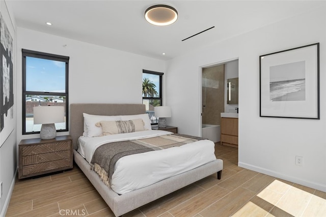 bedroom featuring wood tiled floor, multiple windows, and baseboards