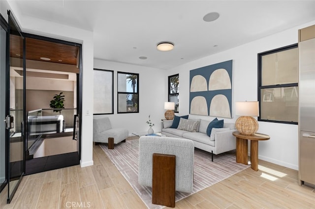 living room with baseboards and wood finish floors