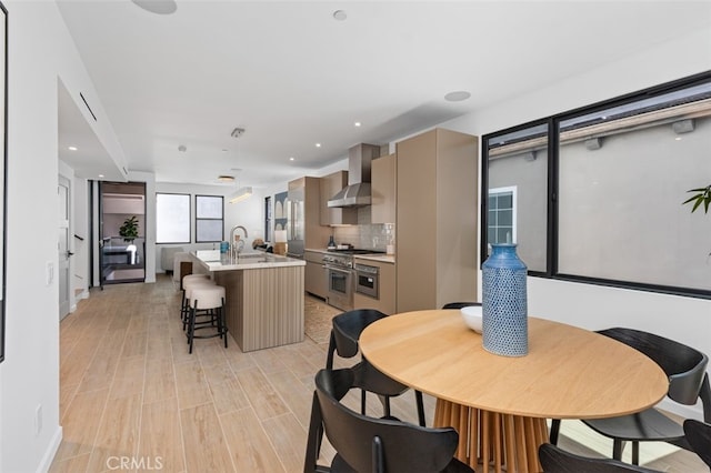 dining room featuring recessed lighting and light wood-type flooring