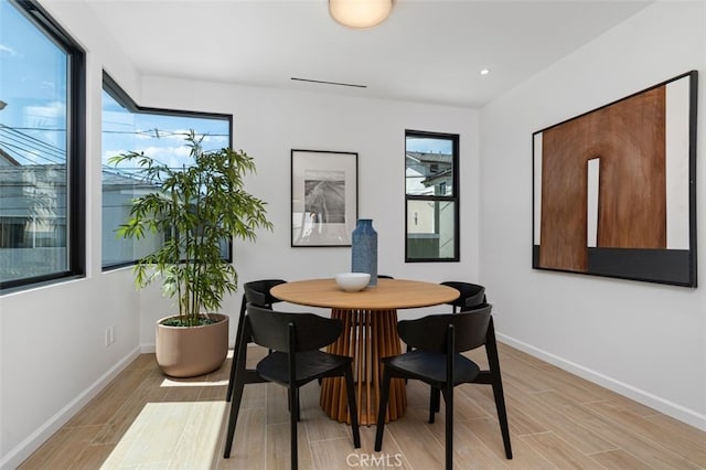 dining area with plenty of natural light, recessed lighting, light wood-style floors, and baseboards