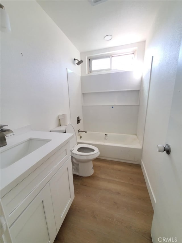 full bathroom featuring toilet, tub / shower combination, wood finished floors, and vanity