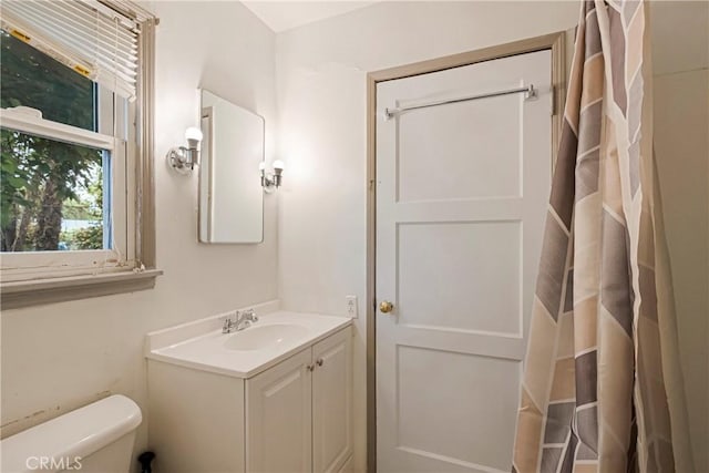 bathroom featuring vanity and toilet