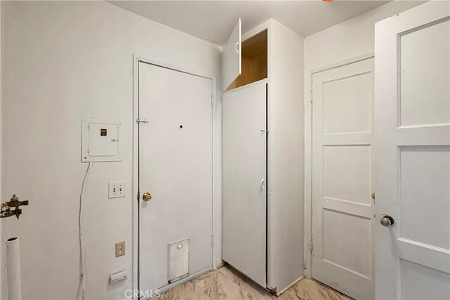 interior space featuring electric panel and marble finish floor