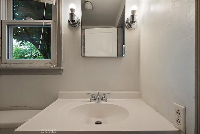 bathroom with vanity and toilet