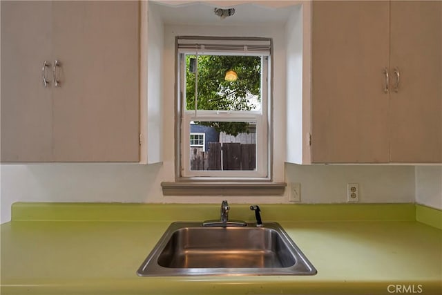 kitchen featuring a sink and light countertops