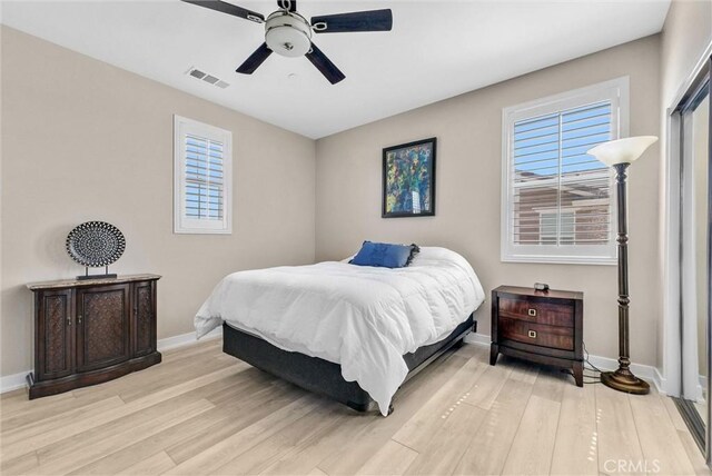 13504 Planet Ct, Riverside, CA 92503 - bedroom featuring baseboards, light wood finished floors, and multiple windows