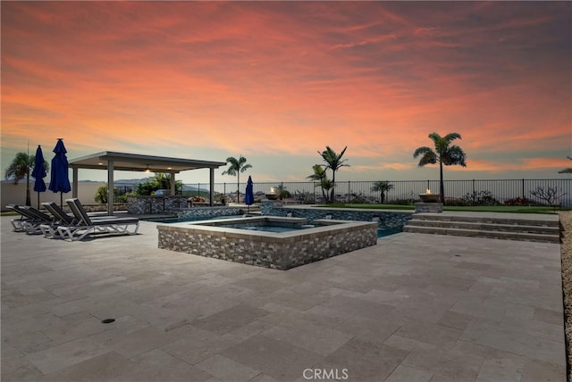 13504 Planet Ct, Riverside, CA 92503 - pool at dusk with a patio, a fenced backyard, a pool, and a hot tub
