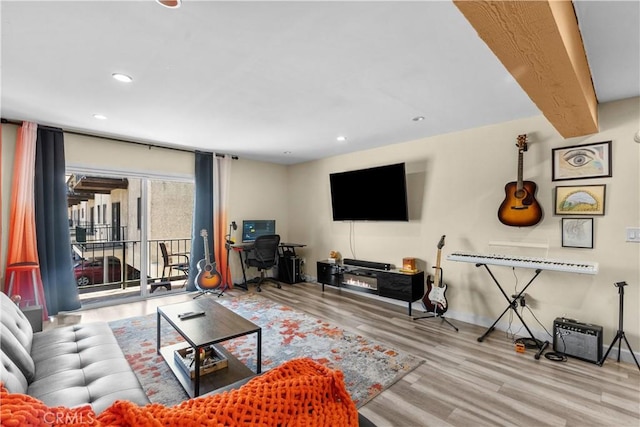 living room with recessed lighting, baseboards, and wood finished floors