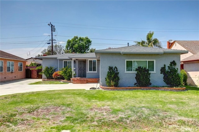single story home with stucco siding and a front yard