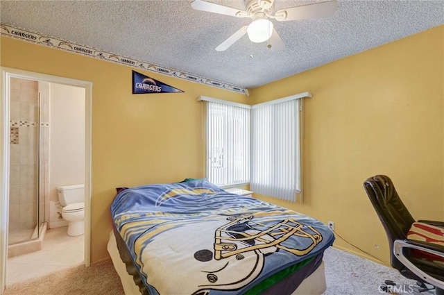 bedroom featuring a textured ceiling, ceiling fan, tile patterned flooring, and ensuite bath
