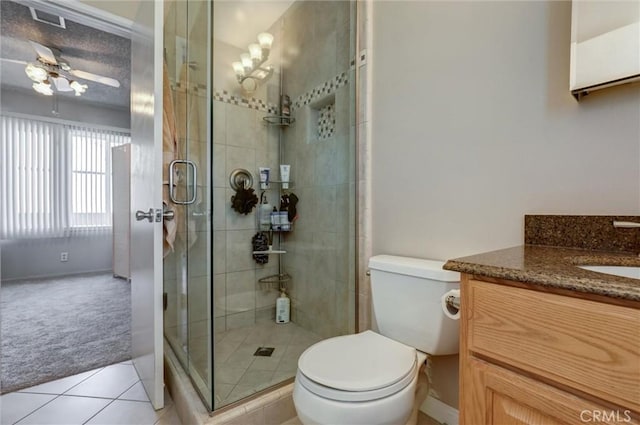 full bathroom featuring vanity, tile patterned flooring, a stall shower, and toilet