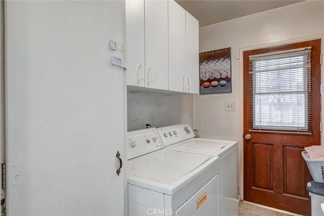 laundry room featuring separate washer and dryer and cabinet space