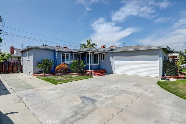 ranch-style home featuring fence, an attached garage, driveway, and stucco siding