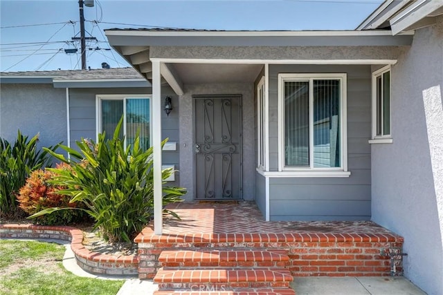 entrance to property with stucco siding