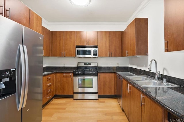 1465 C St Unit 3604, San Diego, CA 92101 - kitchen with appliances with stainless steel finishes, light wood-style flooring, ornamental molding, brown cabinets, and dark stone counters