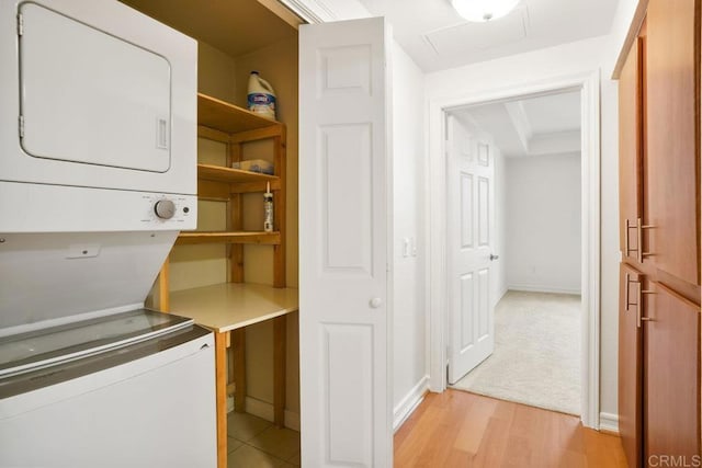 1465 C St Unit 3604, San Diego, CA 92101 - laundry area featuring stacked washer / dryer, attic access, and light wood-type flooring
