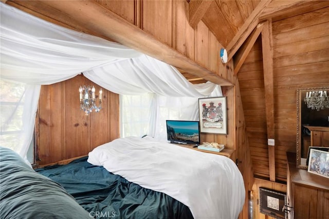 bedroom with wood walls and a chandelier