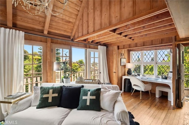 sunroom / solarium featuring french doors and a healthy amount of sunlight