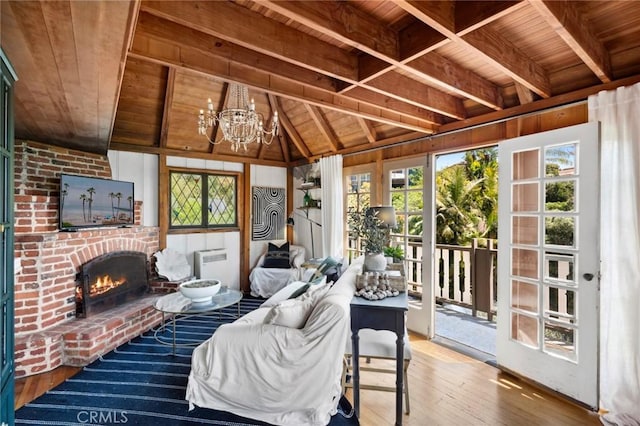 sunroom featuring a chandelier, a wealth of natural light, and beamed ceiling
