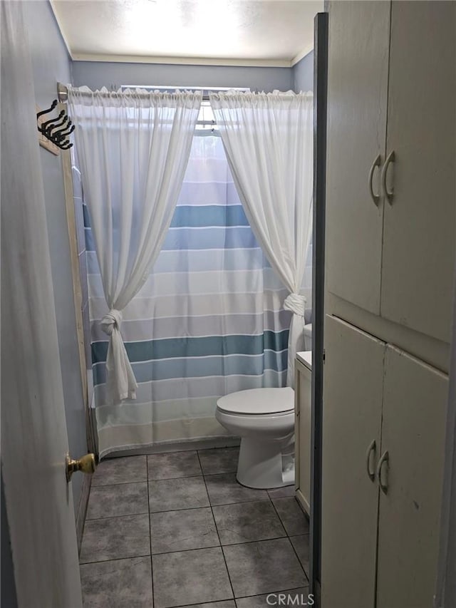 full bathroom with tile patterned flooring, curtained shower, and toilet