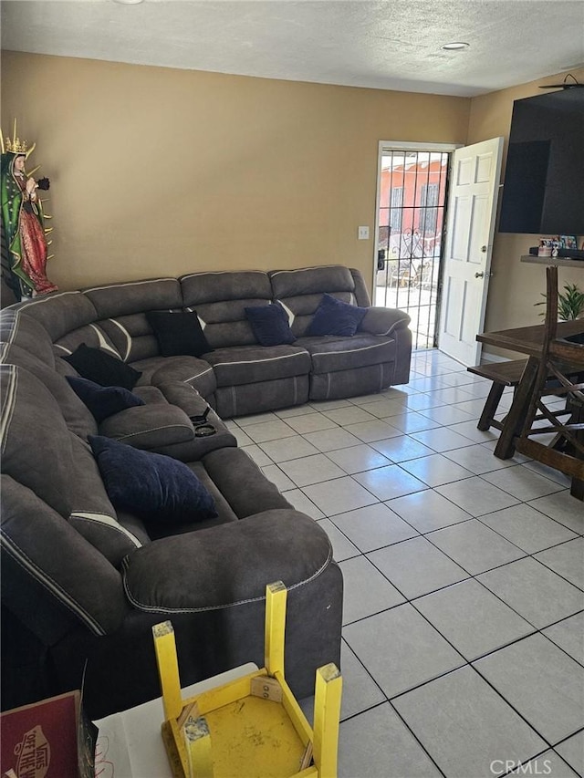 living area with a textured ceiling and light tile patterned floors
