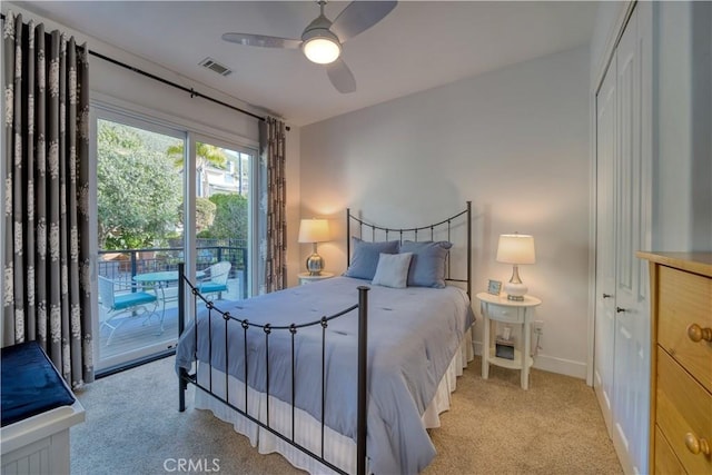 carpeted bedroom with baseboards, visible vents, access to exterior, and ceiling fan