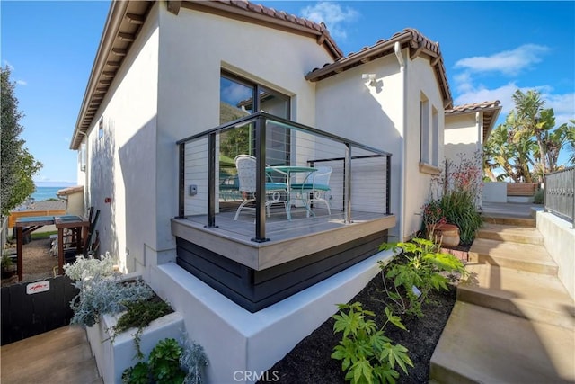 view of property exterior featuring stucco siding and a tile roof