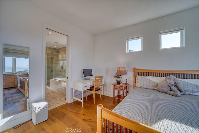 bedroom featuring connected bathroom, recessed lighting, baseboards, and light wood-style floors