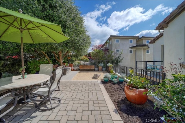 view of patio with fence and outdoor dining space