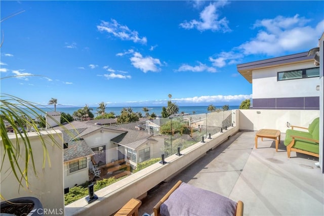 balcony featuring central AC unit and a water view