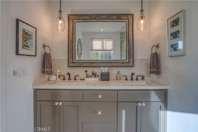 full bath featuring double vanity and a sink