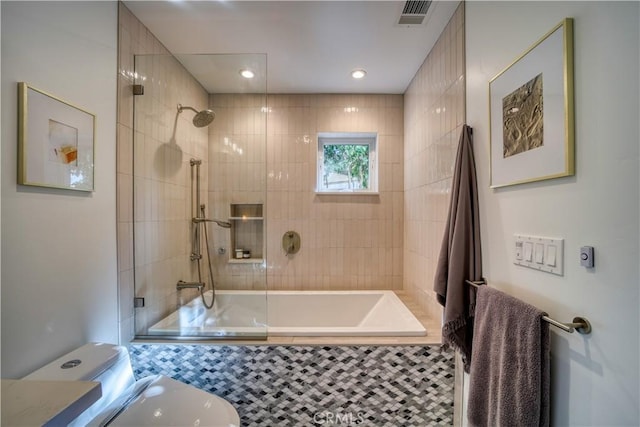 full bathroom with tiled shower / bath combo and visible vents