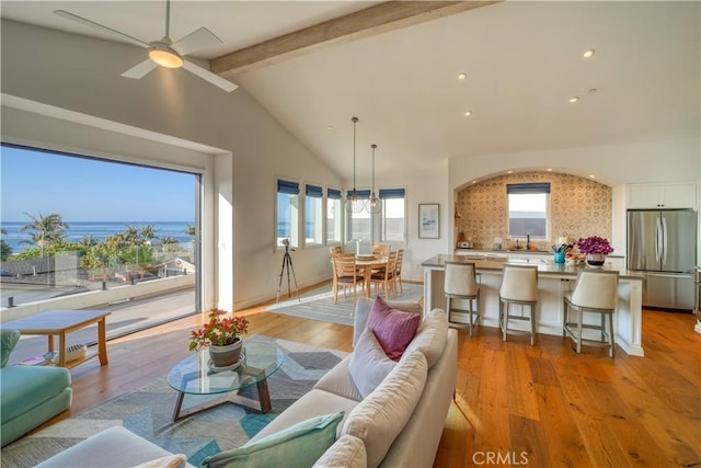 living room featuring light wood-style floors, lofted ceiling with beams, ceiling fan, and recessed lighting