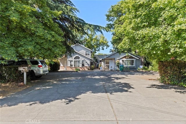 bungalow-style house featuring concrete driveway