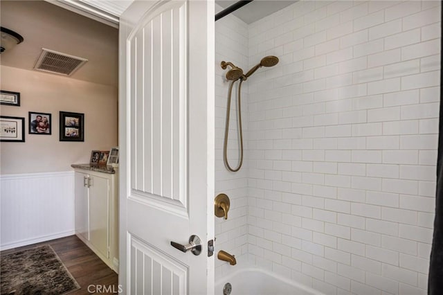 11414 Golden Gate Dr, Yucaipa, CA 92399 - full bathroom with wood finished floors, a wainscoted wall, and bathtub / shower combination
