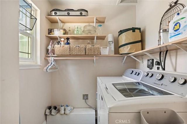 washroom with separate washer and dryer, laundry area, and a healthy amount of sunlight