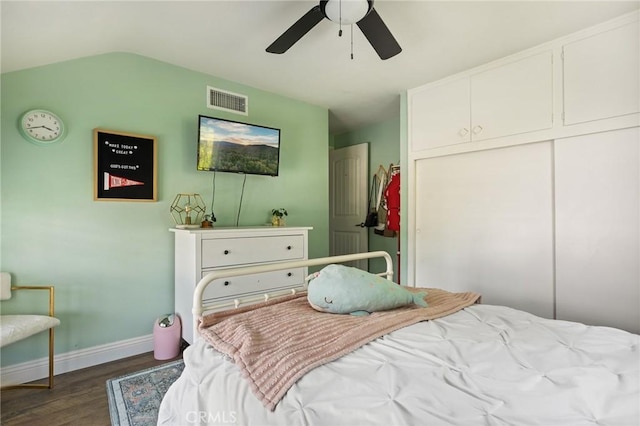 bedroom featuring a ceiling fan, baseboards, wood finished floors, visible vents, and a closet